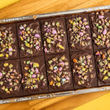 Load image into Gallery viewer, Caramel Shortbread Crushed Smartie Top Traybake
